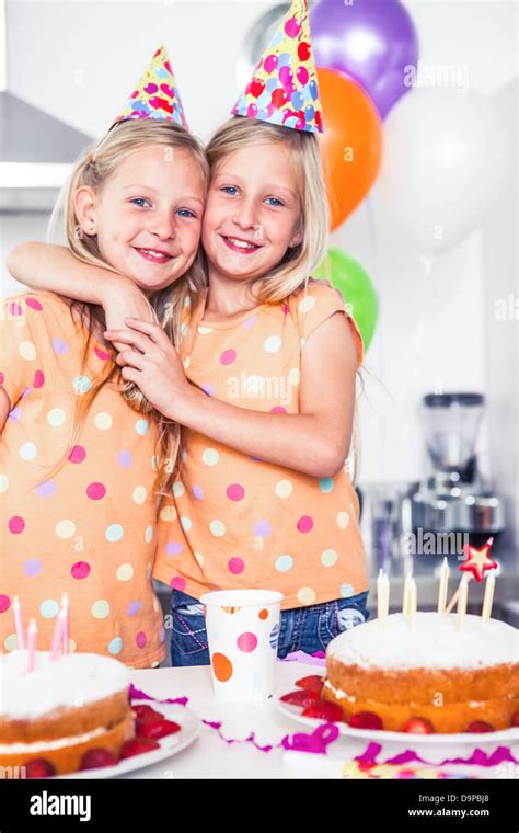 Twins celebrating birthday with separate cakes