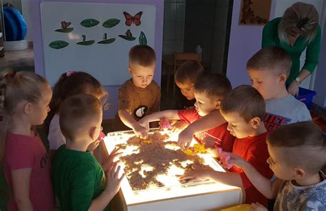 vaikas ir specialistas dirba su smėlio terapija