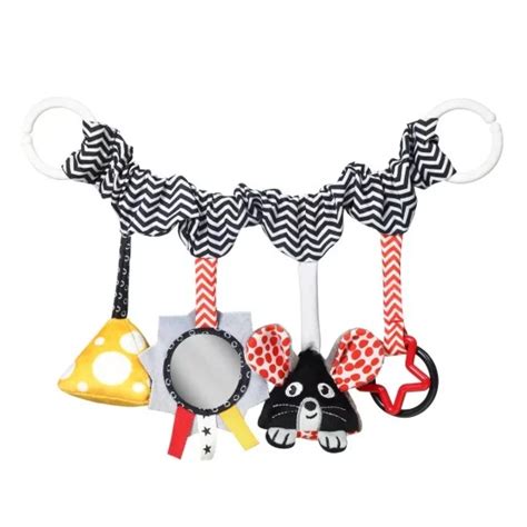 Kūdikis, besidžiaugiantis spalvingais vežimėlio raštais