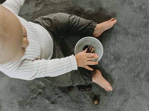 Septynių mėnesių kūdikis, tyrinėjantis žaislą rankomis