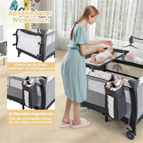 kūdikis vežimėlyje su pakabinamu žaislu